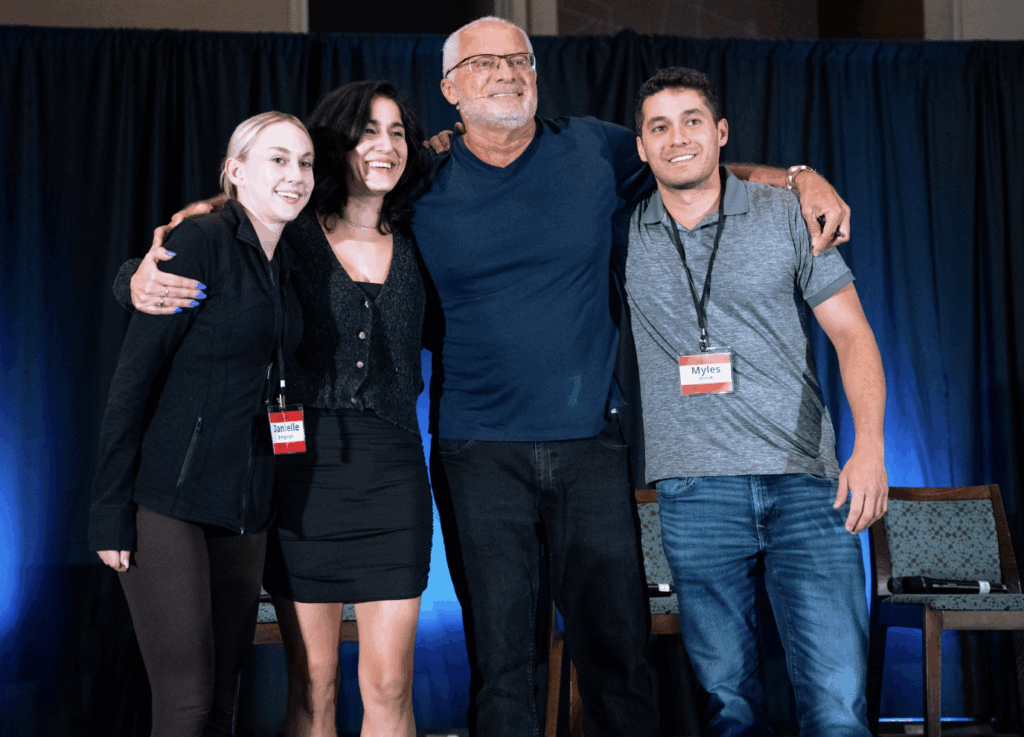Rod Khleif on stage with his children